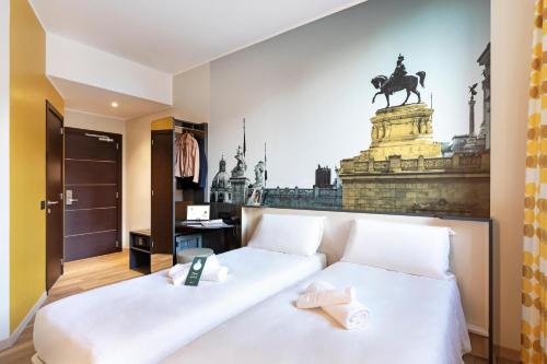 a hotel room with a bed with a statue of a horse on the wall at B&B Hotel Roma San Lorenzo Termini in Rome
