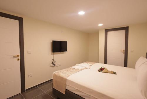 a bedroom with a bed with a tv on the wall at Pekin Spa and Suites in Istanbul