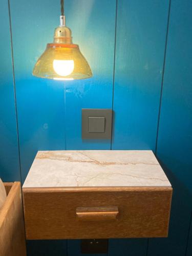 a blue room with a table with a light on it at Casa Bauxells in Sahorre