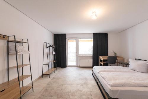 a bedroom with a bed and a desk and a table at Palatium Bad Ems in Bad Ems