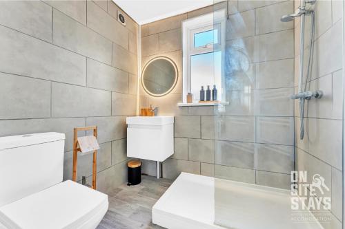 a bathroom with a toilet and a shower at OnSiteStays - 3 bedroom, 2 x space driveway and Wifi in Rainham