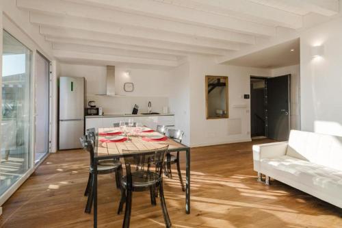 a dining room and kitchen with a table and chairs at Casanova Bluelife in Trieste