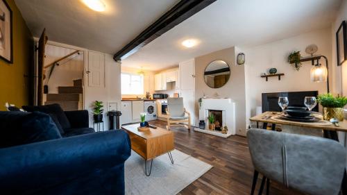 a living room with a couch and a table at Laburnum Cottages - Stratford upon Avon in Stratford-upon-Avon