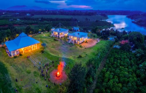 an aerial view of a house with a fire on a field at Du Lịch Lâm Hà - Hồ Gia Trang Villas in Lam Ha