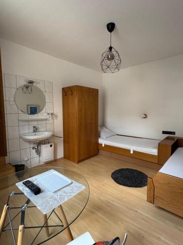 a small room with a bed and a sink at Hotel zum Erwin in Karlsruhe