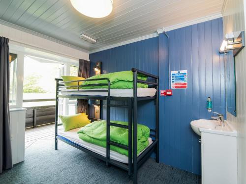 a room with two bunk beds and a sink at YHA Street in Street