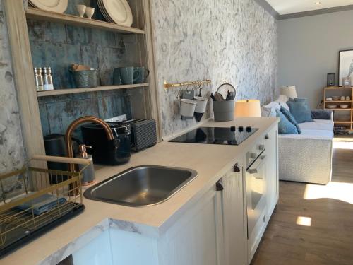 a kitchen with a sink and a counter top at Wohnung Midcoast im Herzen von Schleswig-Holstein in Nortorf