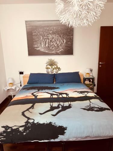 a bedroom with a bed with a painting on the wall at Casa Giulia in Cantù