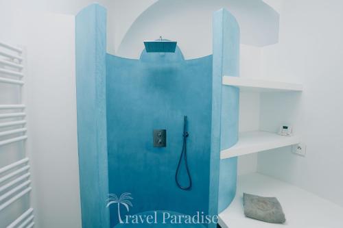 a bathroom with a shower with a blue wall at Villa La Saliere in Saint-Clément-des-Baleines