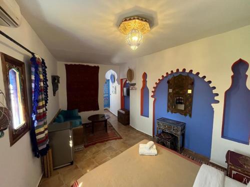a living room with a couch and a fireplace at Casa Blue Star in Chefchaouene