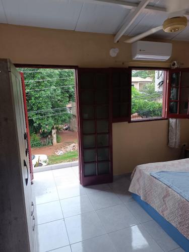 a room with a bed and an open door at Habitación para 2 personas in Villa Elisa