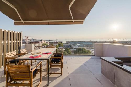 a dining room with a table and chairs on a balcony at Casanova Bluelife in Trieste