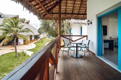 a balcony of a house with a table and chairs at Villa dos Poetas in Barra Grande