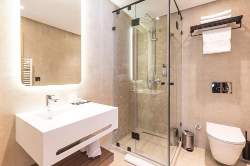 a bathroom with a sink and a shower at Citadines Almaz Aparthotel Casablanca in Casablanca