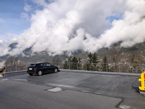 a car parked in a parking lot in front of a mountain at Hobbithöhle in Imsterberg