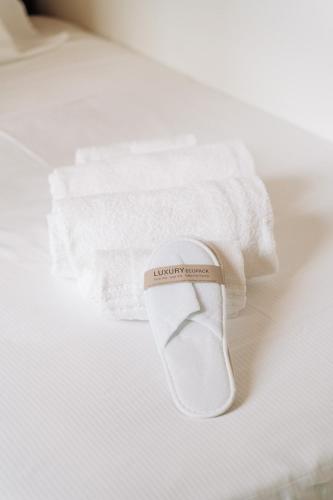 a pair of towels and a sock on a bed at Youhosty - Brera 17 in Milan