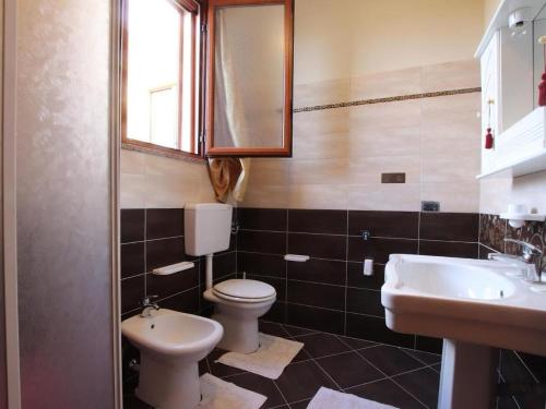 a bathroom with a toilet and a sink and a mirror at Casa Angela Lampedusa in Lampedusa