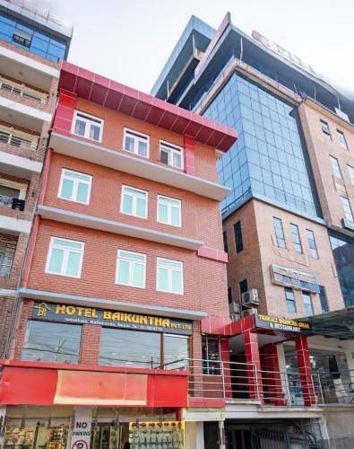 a red brick building with a hotel kiryatollah at OYO 825 Hotel Baikuntha in Kathmandu
