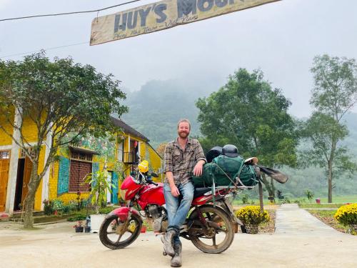 a man is sitting on a red motorcycle at Hieu-Homestay in Phong Nha