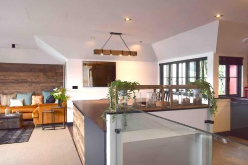 a kitchen and living room with a counter and a couch at Stunning Waterfront Apartment With Spectacular Views & Parking at 'CAPTAINS LOFT' in Falmouth