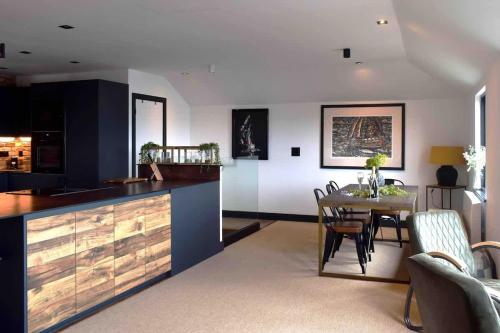a kitchen with a table and a dining room at Stunning Waterfront Apartment With Spectacular Views & Parking at 'CAPTAINS LOFT' in Falmouth