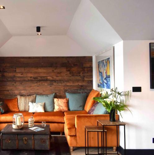 a living room with a couch and a table at Stunning Waterfront Apartment With Spectacular Views & Parking at 'CAPTAINS LOFT' in Falmouth