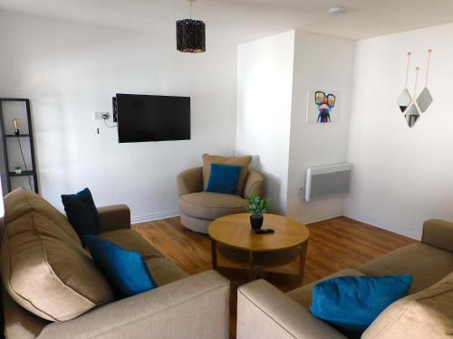 a living room with two couches and a table at No 5 - Modern 2 bedroom Apartment in Lanark Town Centre in Lanark