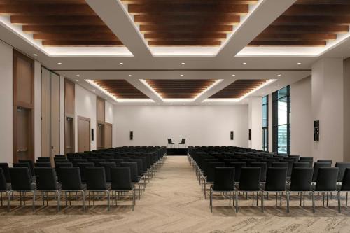 an empty room with black chairs and a white wall at AC Hotel by Marriott Reston in Reston