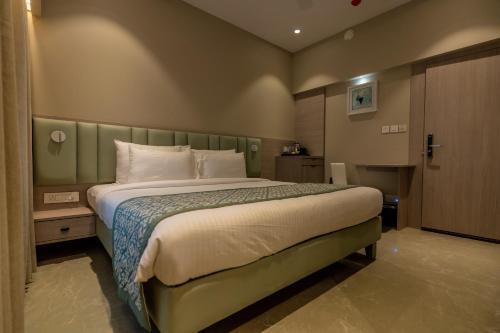 a bedroom with a large bed in a room at Hotel 24K Nagpur in Nagpur