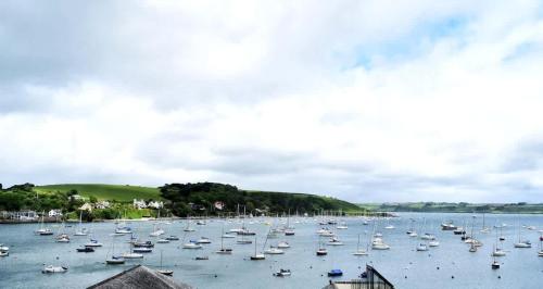 a large group of boats sitting in the water at Breathtaking High Street Townhouse With Stunning Sea Views at 'The Old Fishermans Townhouse' in Falmouth