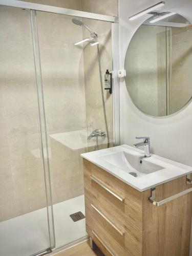 a bathroom with a sink and a shower at A Paradiña de Sarria in Sarria
