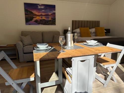 a living room with a table and a couch at Craig-y-Dderwen Riverside Hotel in Betws-y-coed