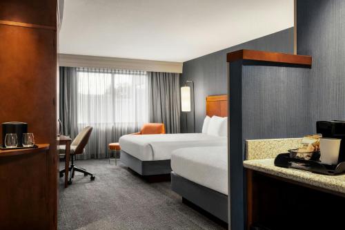 a hotel room with a bed and a desk at Courtyard Mt. Holly Westampton in Westampton Township