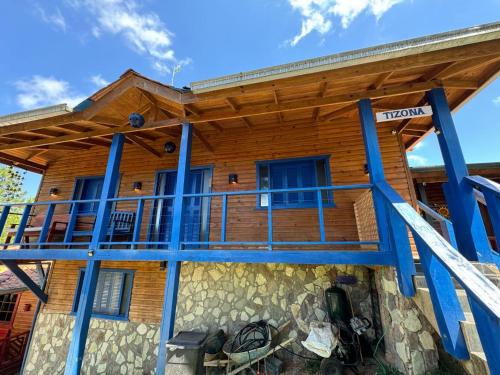 a log cabin with a porch and a deck at Estancias Arroyazo in Constanza