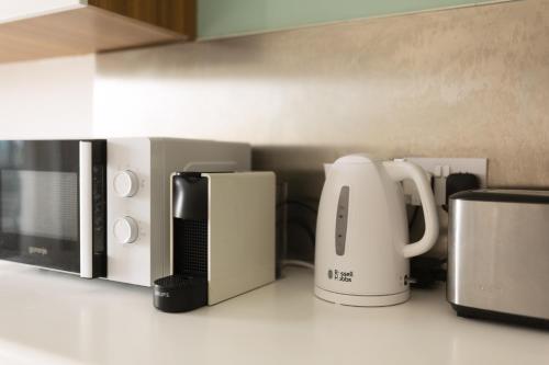 a kitchen with various appliances on a counter at Large & modern 3 bedrooms near Spinola Bay MMAI1-3 in St. Julianʼs