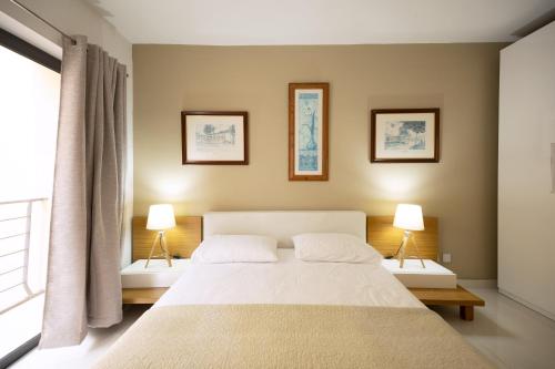 a bedroom with a large white bed with two lamps at Large & modern 3 bedrooms near Spinola Bay MMAI1-3 in St. Julianʼs
