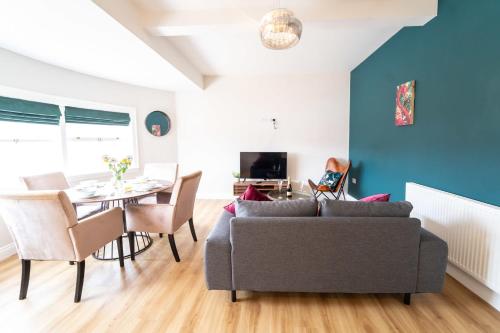 a living room with a couch and a table at King Street Penthouse - 2 Bed in Great Yarmouth