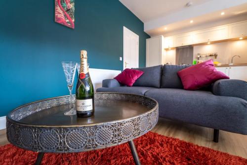 a bottle of wine on a table in a living room at King Street Penthouse - 2 Bed in Great Yarmouth