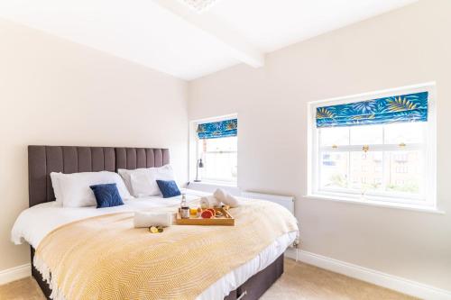 a bedroom with a large bed with a tray on it at King Street Penthouse - 2 Bed in Great Yarmouth