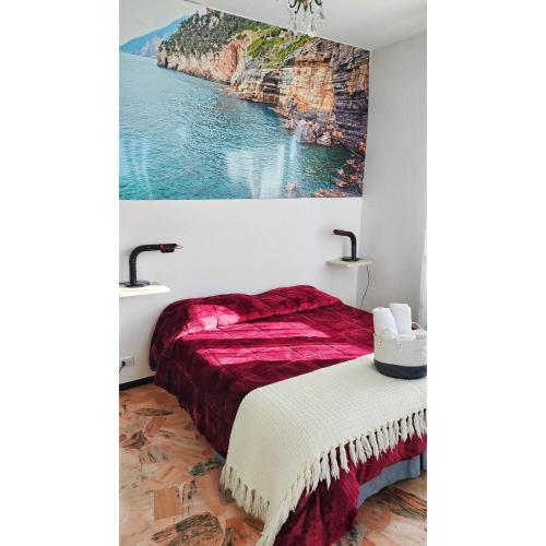 a bedroom with a bed and a painting on the wall at B&B Petit déjeuner in Chiavari