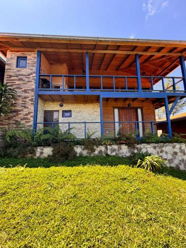 a house with a large deck on the side of it at Estancias Arroyazo in Constanza