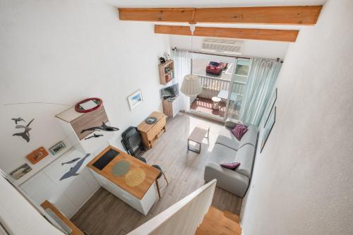 an overhead view of a living room with a table at AS25806-P2 cabine duplex avec terrasse et parking in Le Grau-du-Roi