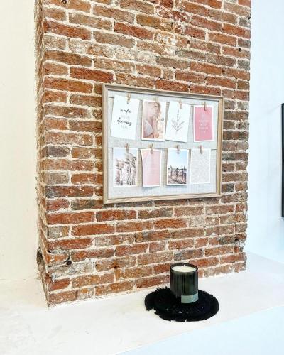 a brick wall with a picture on it at NEW SPACIOUS boutique apartment's in the center of Antwerp in Antwerp