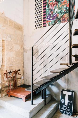 a set of stairs with a sign next to it at Il Granile Contemporary Loft in Matera