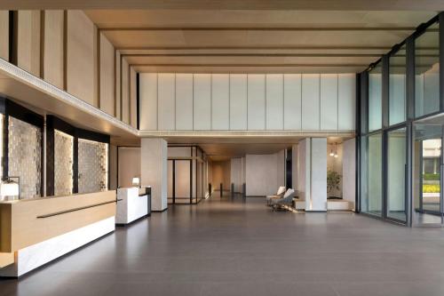 an empty lobby of a building with glass windows at Fairfield by Marriott Bijie in Bijie