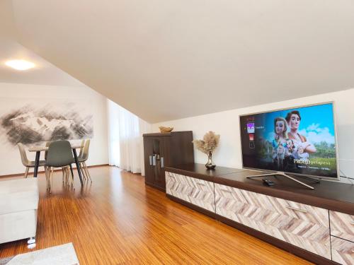 a living room with a large flat screen tv at Apartments Tatra Olla - Tatranská Lomnica in Tatranská Lomnica