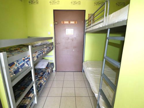 une porte menant à une chambre avec des lits superposés. dans l'établissement Studio climatisé avec piscine, parking, terrasse, proche plage et commerces - FR-1-307-88, au Grau-du-Roi