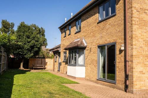a brick building with a window on the side of it at Burgess Beach House in Caister-on-Sea