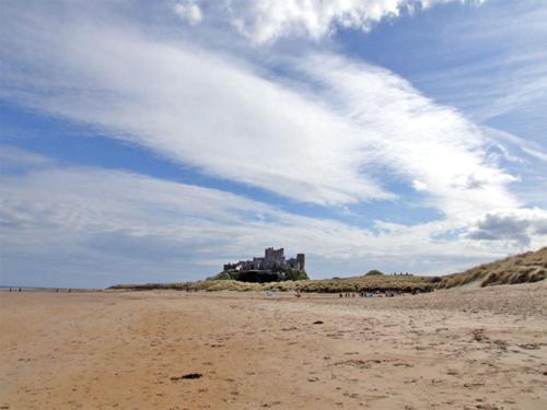 a castle sitting on top of a sandy beach at Bank View in Duns