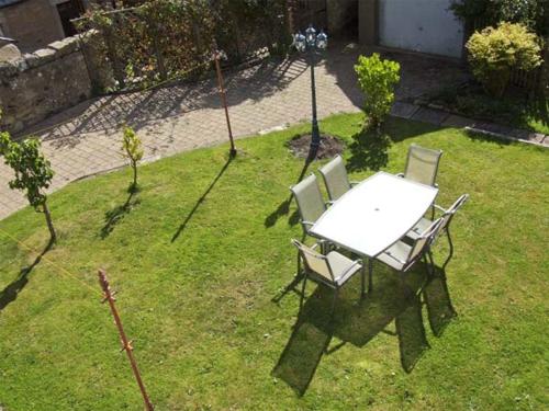 a white table and chairs in a yard at Bank View in Duns